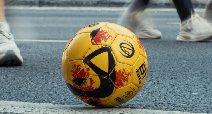 gele bal met strepen op straat